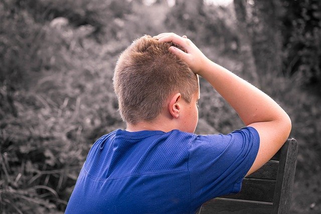 boy touching head