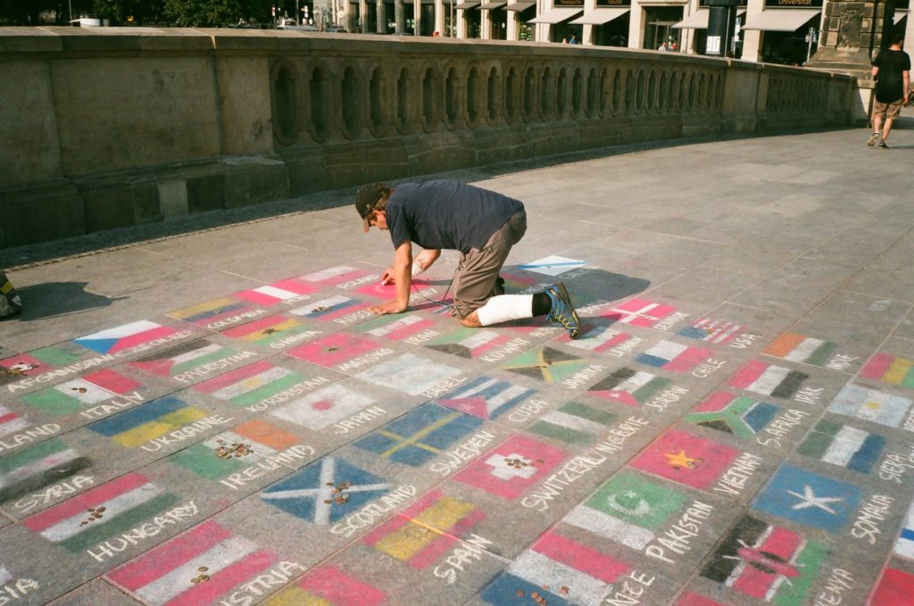 man drawing national flags