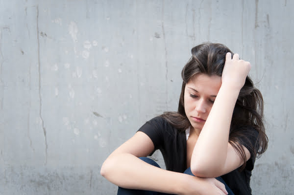 woman sitting in a curled up position