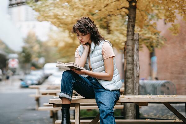 reading book on street